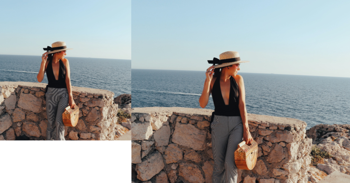 Picture of a woman looking at the ocean. Wearing a black swimsuit and a hat